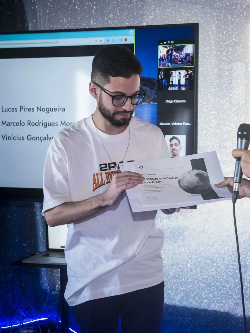 A photo of me receiving my Human Coder certificate at 42 São Paulo